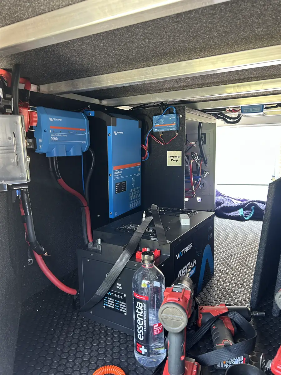 Open chassis bay and field tooling during a mobile RV diagnostics visit.